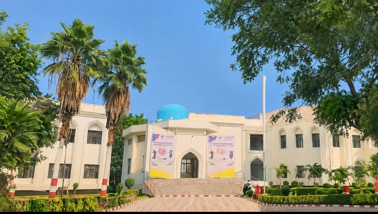KBNU campus building framed by trees